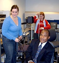 CTC VISTAs Alli Shaughnessy and Jennifer Schmitt work on the filming of an EITC PSA with Alan Gentile of the Roxbury Resource Center.